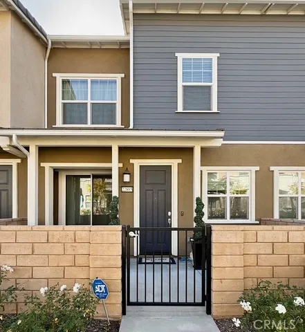 front view of a brick house with a large window