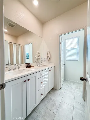 a spacious bathroom with a granite countertop sink mirror and