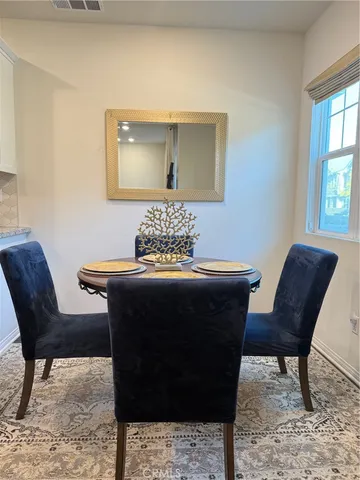 a living room with a couch and a potted plant