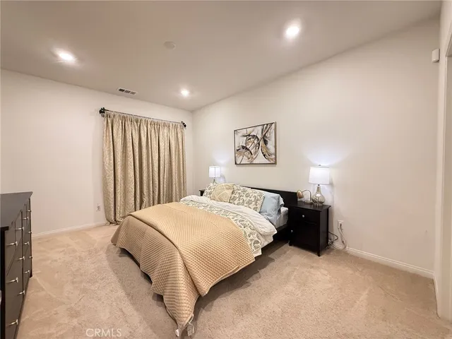 a bedroom with a bed and a night stand
