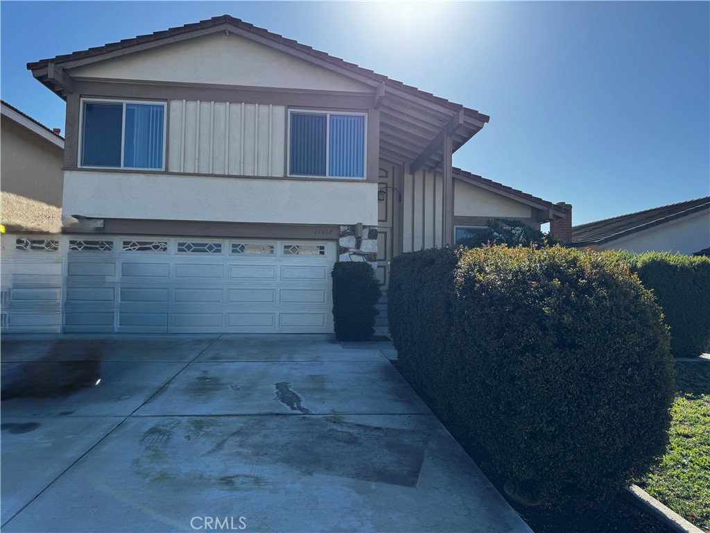 14612 Beach Irvine, CA 92606 - Photo 1 of 1 a front view of a house with a yard and garage