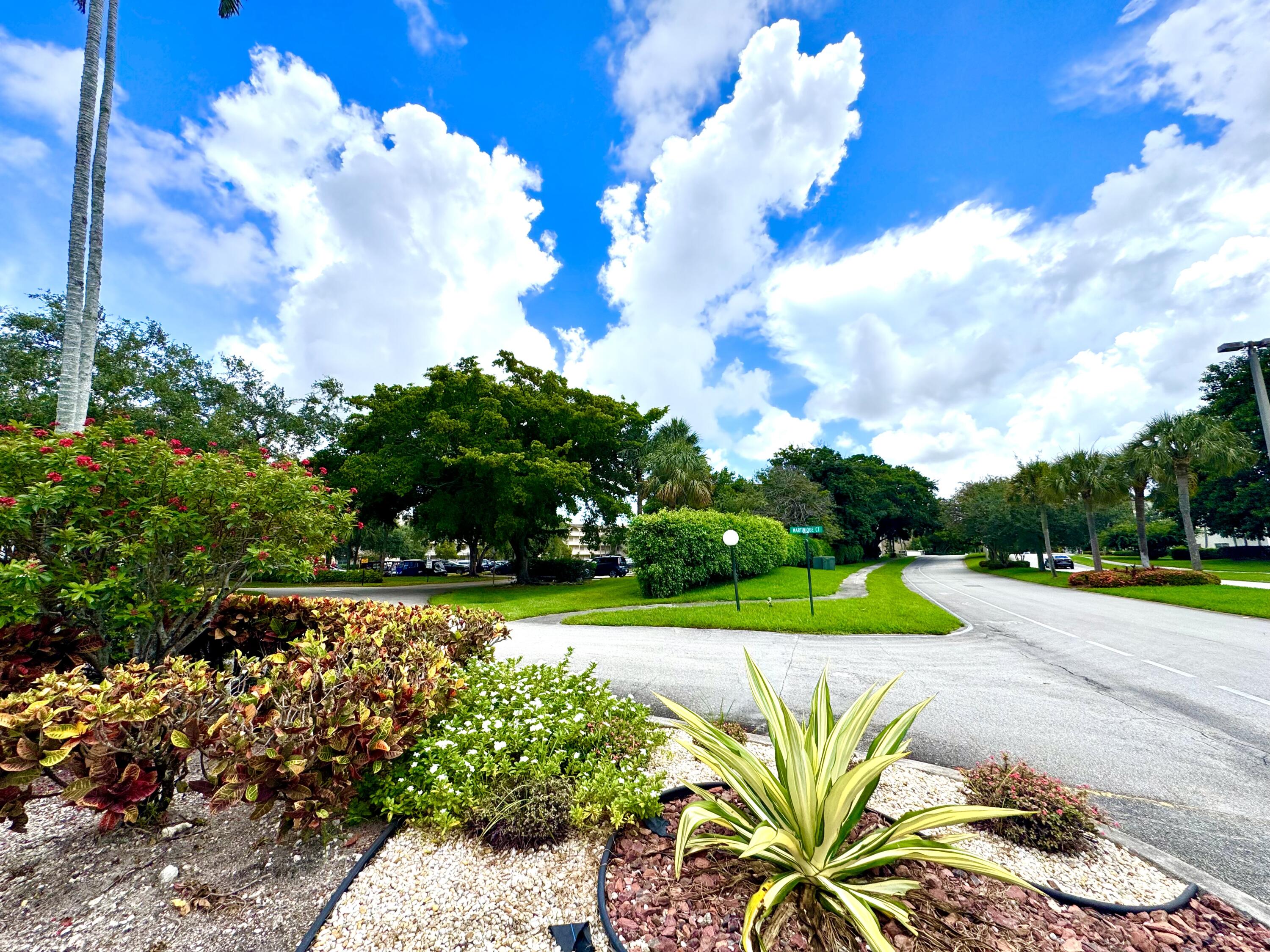 4401 Martinique Court, Unit G2 Coconut Creek, FL 33066 - Photo 17 of 22 a view of a yard with plants and large trees