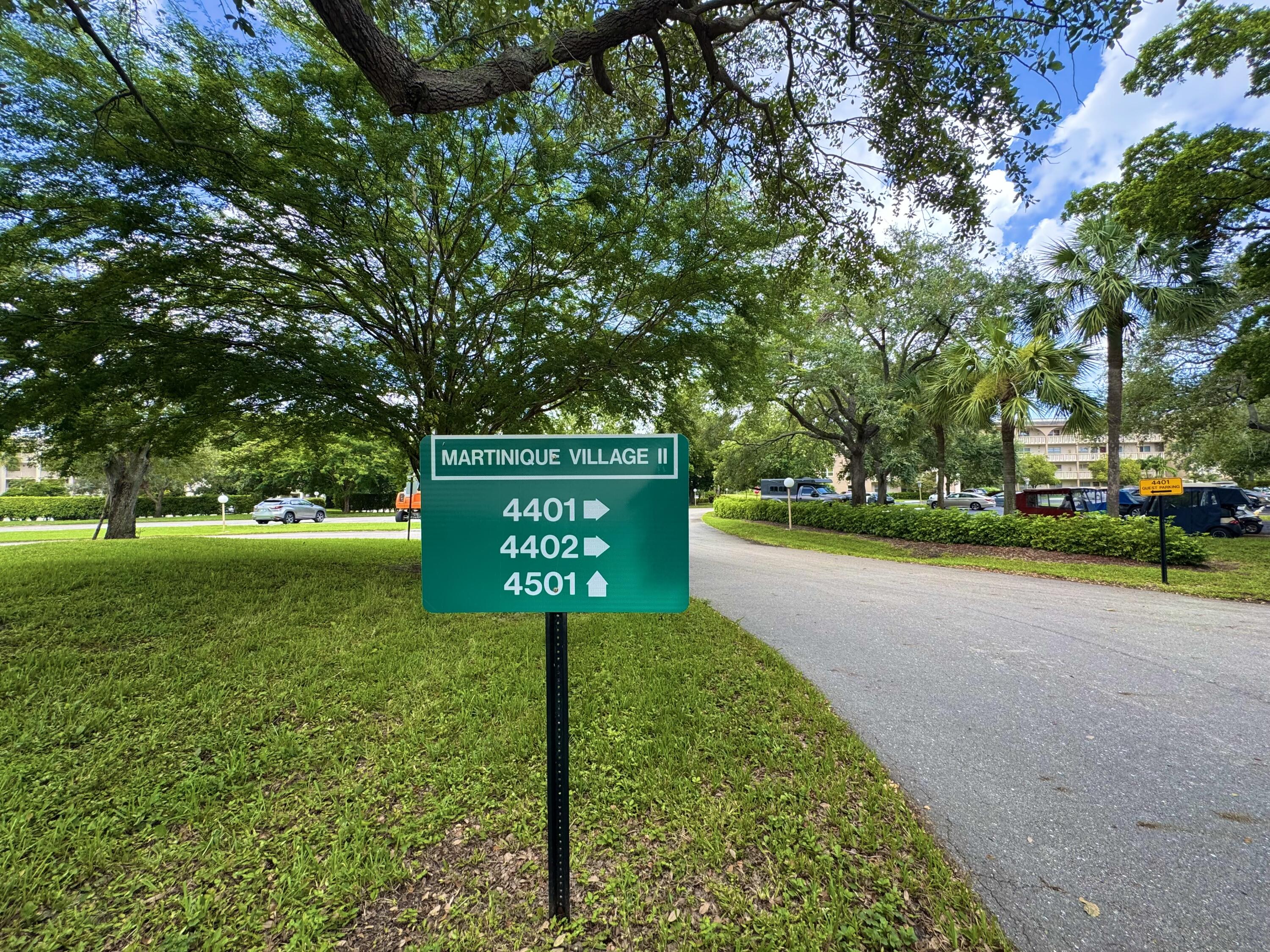 4401 Martinique Court, Unit G2 Coconut Creek, FL 33066 - Photo 19 of 22 a sign board with a play ground in the back yard