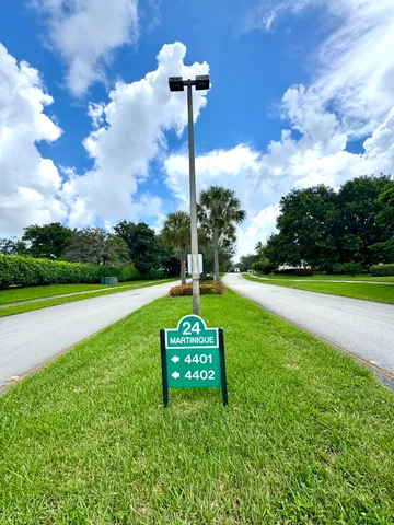 a view of a swimming pool with a lawn chairs and plants