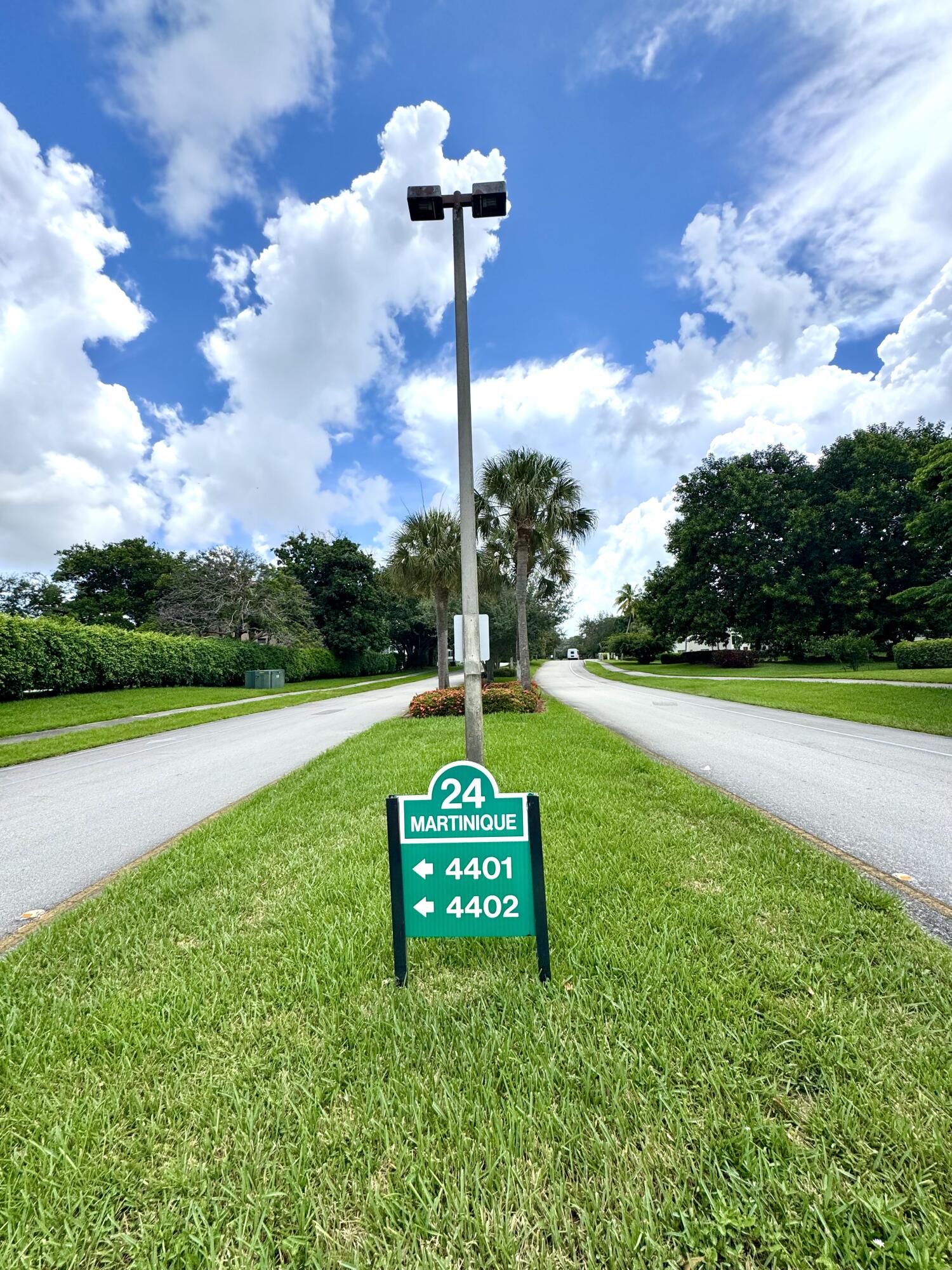 4401 Martinique Court, Unit G2 Coconut Creek, FL 33066 - Photo 20 of 22 a sign board with a house in the background