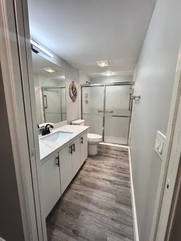 a large white bathroom with sink mirror and shower