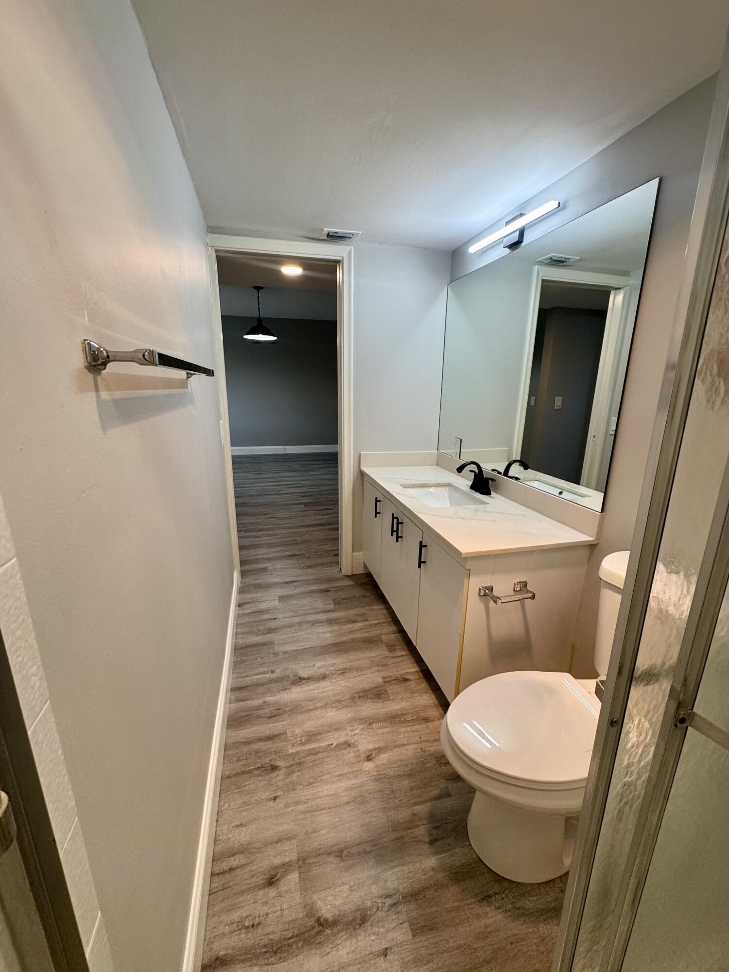 4401 Martinique Court, Unit G2 Coconut Creek, FL 33066 - Photo 7 of 22 a bathroom with a sink a toilet a mirror and vanity