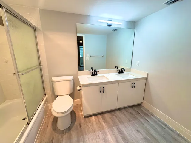 a bathroom with a toilet sink and a mirror