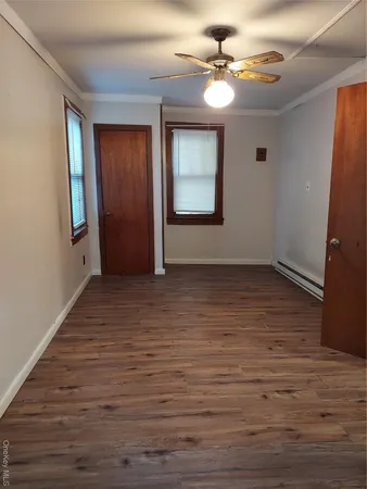 wooden floor in an empty room with a window