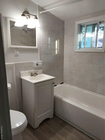 a bathroom with a sink a toilet and bathtub