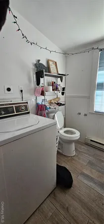 a room with stainless steel appliances a stove a window and cabinets