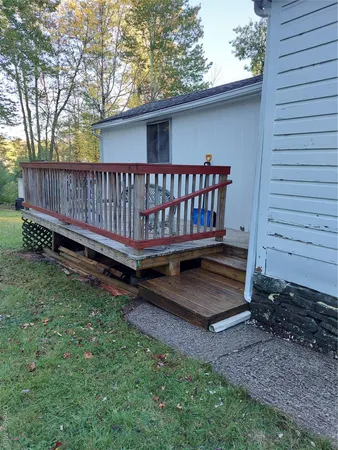 a view of a backyard with a small yard and wooden fence