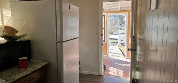 a kitchen with a refrigerator and window