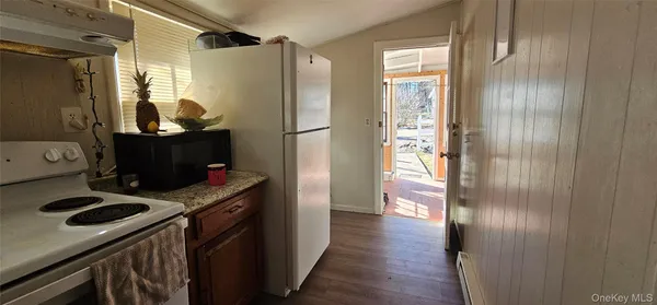a kitchen with a refrigerator and a stove