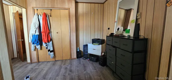 a view of a bedroom with clothes and shoes