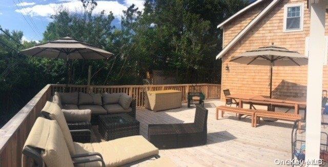 368 Surf Road Ocean Beach, NY 11770 - Photo 11 of 11 a roof deck with table and chairs under an umbrella