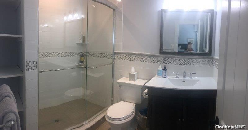 368 Surf Road Ocean Beach, NY 11770 - Photo 8 of 11 a bathroom with a sink toilet and shower