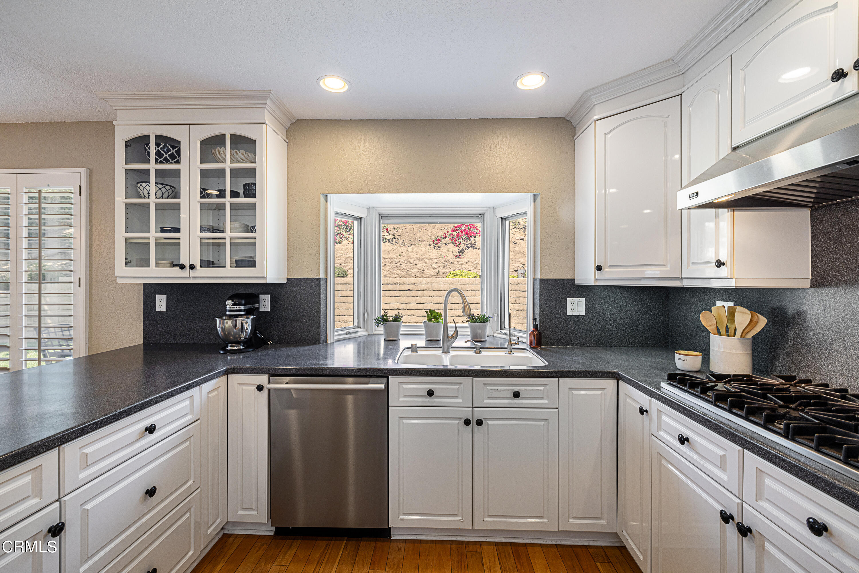 2891 Corte Caballos Camarillo, CA 93010 - Photo 8 of 30 a kitchen with granite countertop a sink a window stainless steel appliances and cabinets