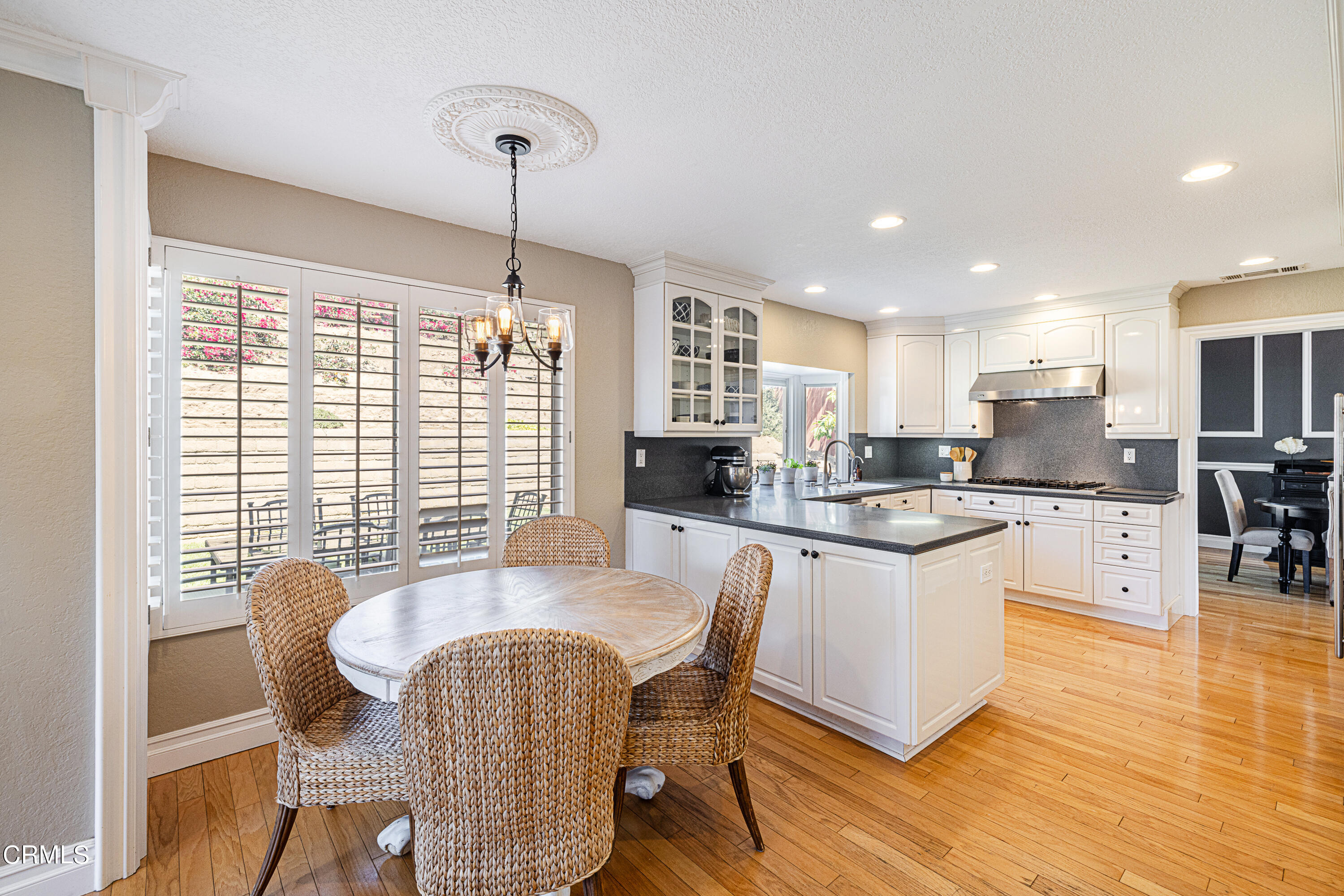 2891 Corte Caballos Camarillo, CA 93010 - Photo 9 of 30 a kitchen with stainless steel appliances granite countertop a stove a sink a microwave a dining table and chairs