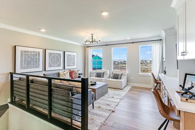 a living room with furniture a wooden floor and chandelier