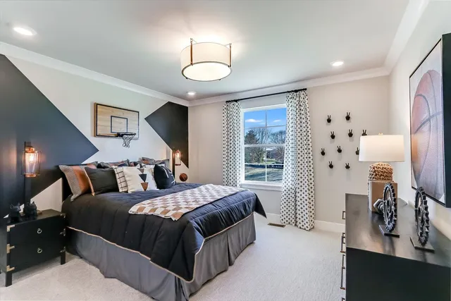 a bedroom with a large bed and a flat tv screen on dresser