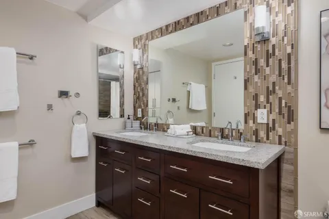 a view of a hallway with wooden floor windows and a livingroom