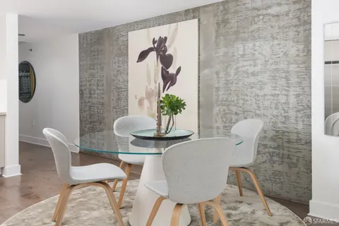 a dining room with furniture and wooden floor