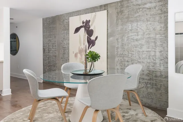 a dining room with furniture and wooden floor