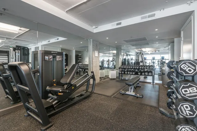 a view of a cars park in front of a building