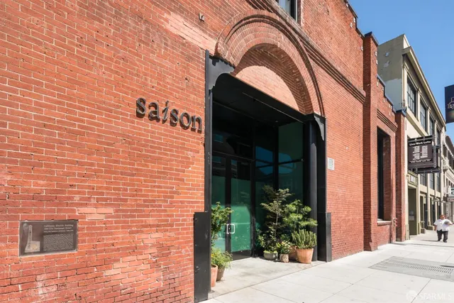 a living room with furniture cabinetry and a dining table