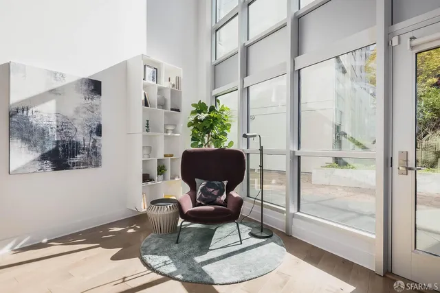 a living room with furniture and floor to ceiling windows