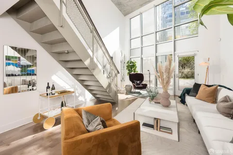 a kitchen with granite countertop a sink stove and cabinets