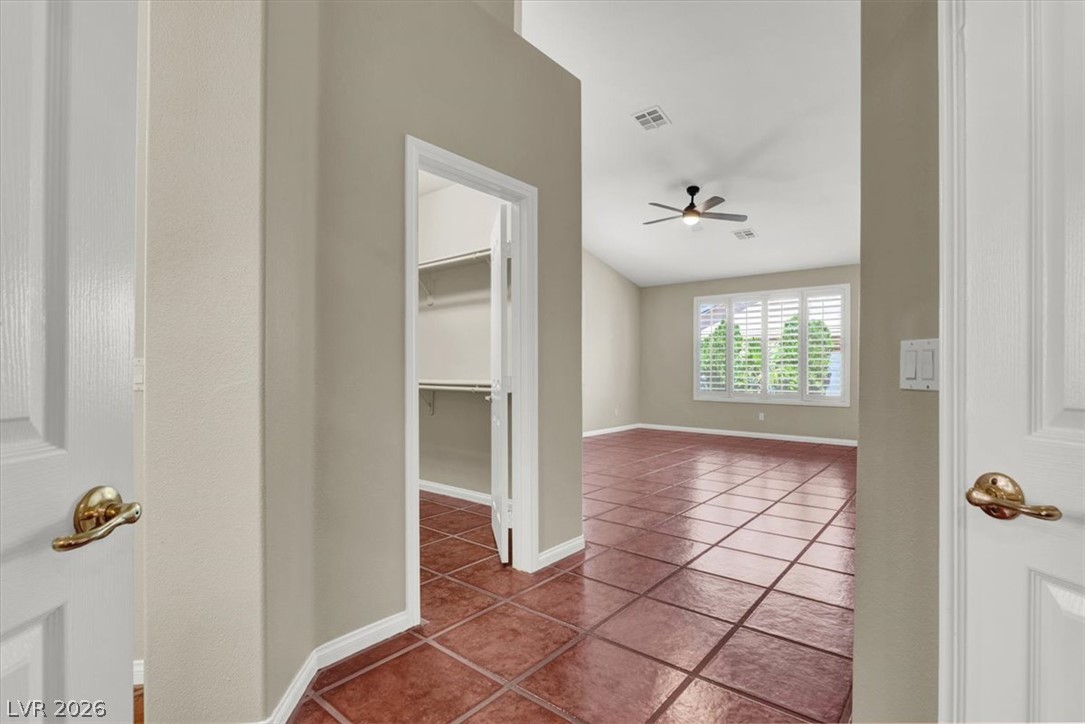 7308 Rustic Meadow Street Las Vegas, NV 89131 - Photo 17 of 27 Sun-filled room boasts high ceilings and durable tile flooring, with a conveniently located walk-in closet.