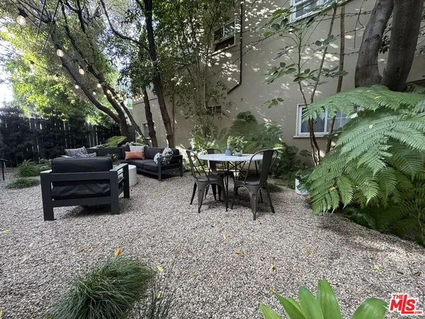 a view of backyard with outdoor seating and green space