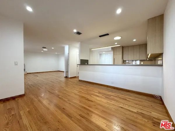 a view of a kitchen with a sink and a refrigerator