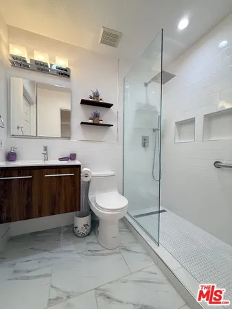 a bathroom with a toilet a sink and shower