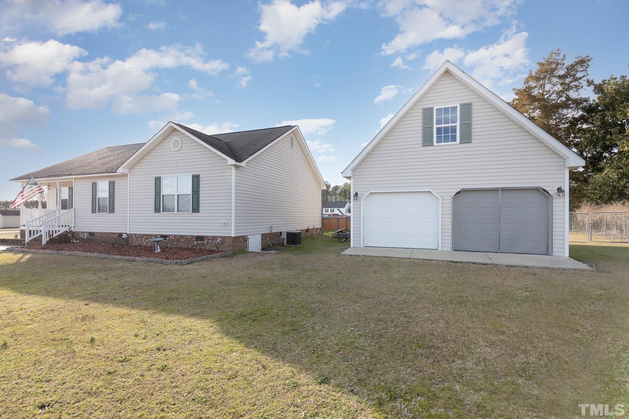 50 Wagner Road Willow Spring, NC 27592 - Photo 3 of 18 a view of a house with a yard and garage