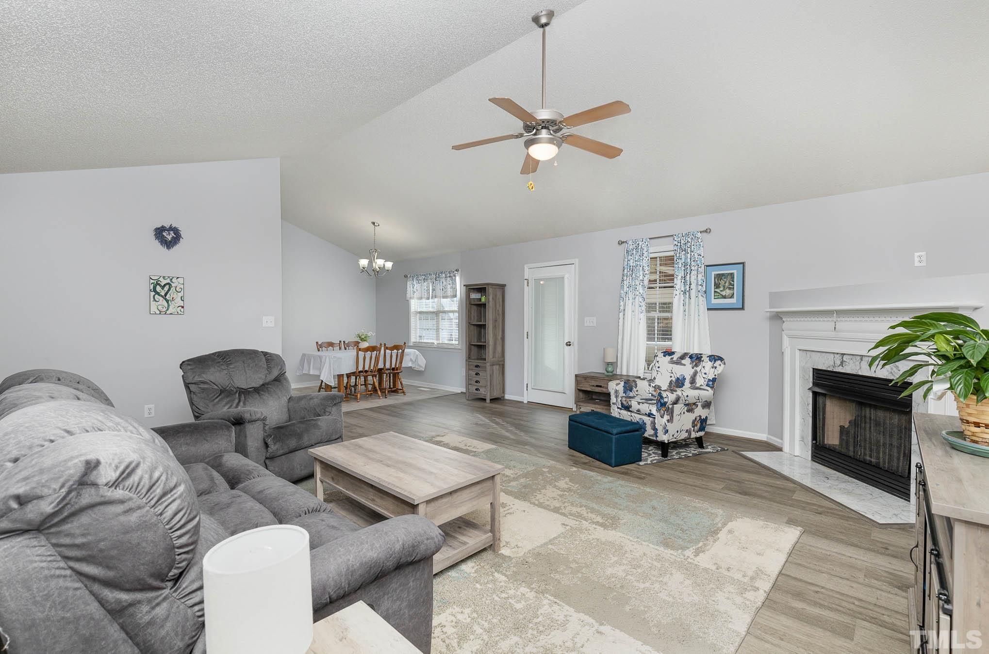 50 Wagner Road Willow Spring, NC 27592 - Photo 5 of 18 a living room with furniture and a fireplace