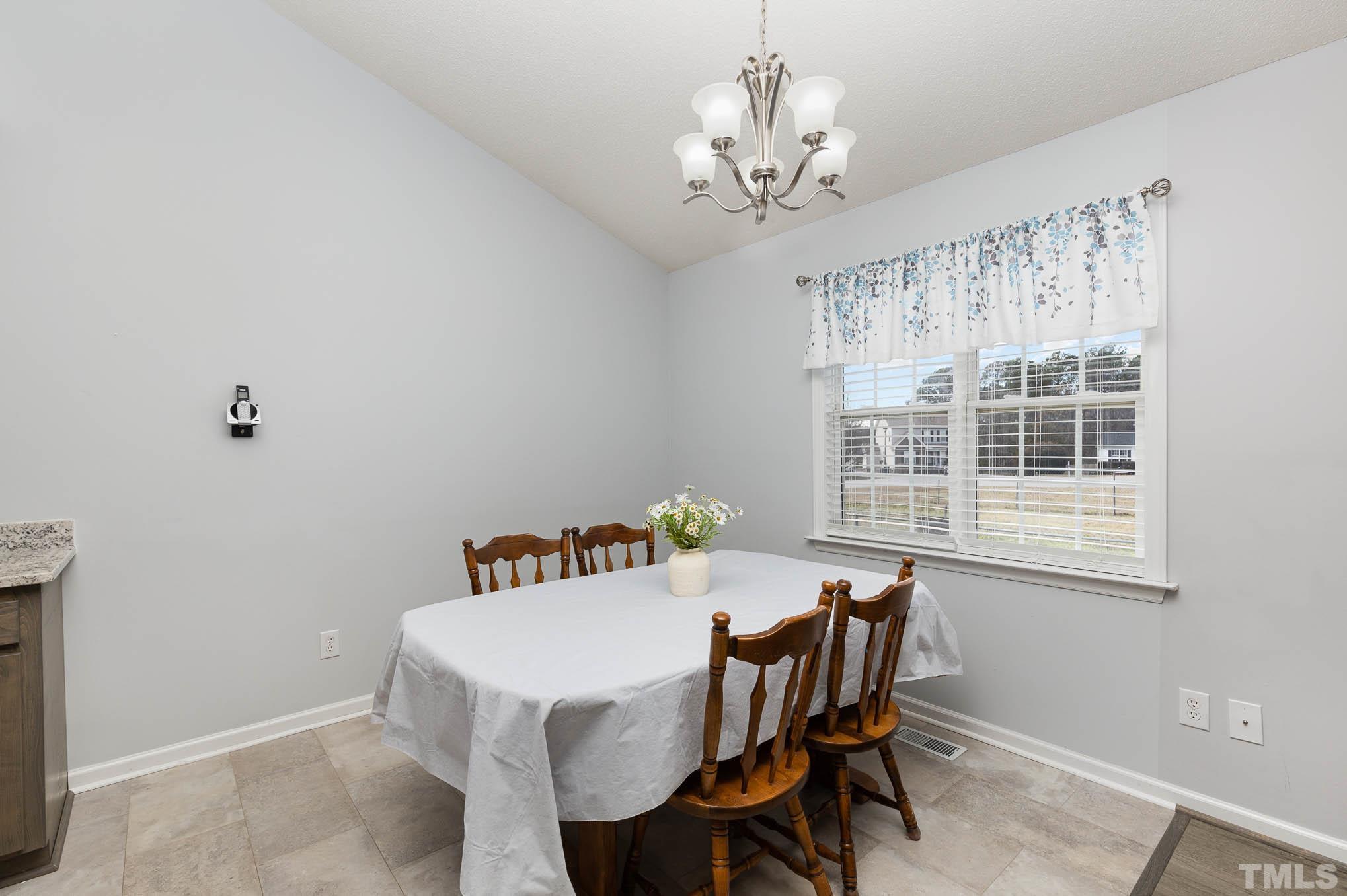 50 Wagner Road Willow Spring, NC 27592 - Photo 6 of 18 a view of a dining room with furniture window and outside view