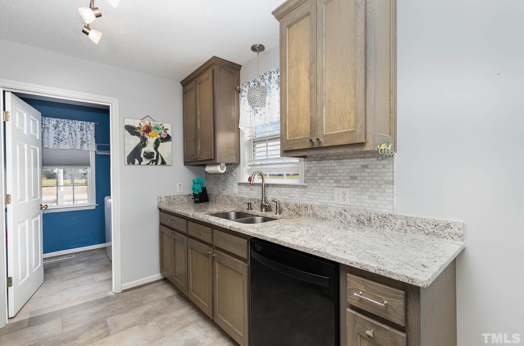 50 Wagner Road Willow Spring, NC 27592 - Photo 8 of 18 a bathroom with a granite countertop sink and a mirror