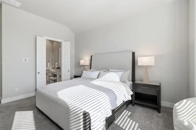 a bedroom with a bed and a night stand