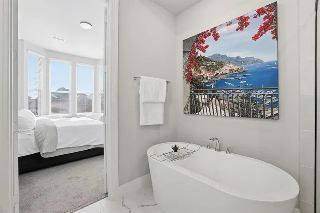 a bathroom with a bathtub and a window