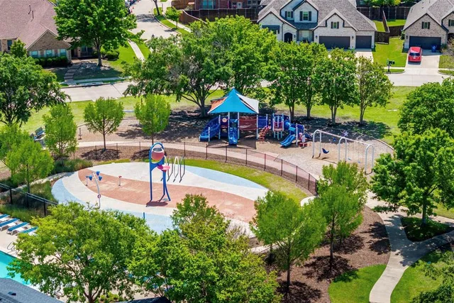 an aerial view of a house with swimming pool garden and patio