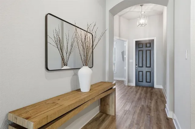a view of a hallway with wooden floor and glass door