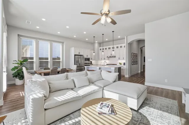 a living room with furniture and a chandelier