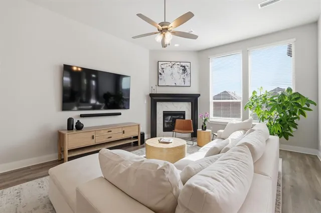 a living room with furniture a flat screen tv and a fireplace