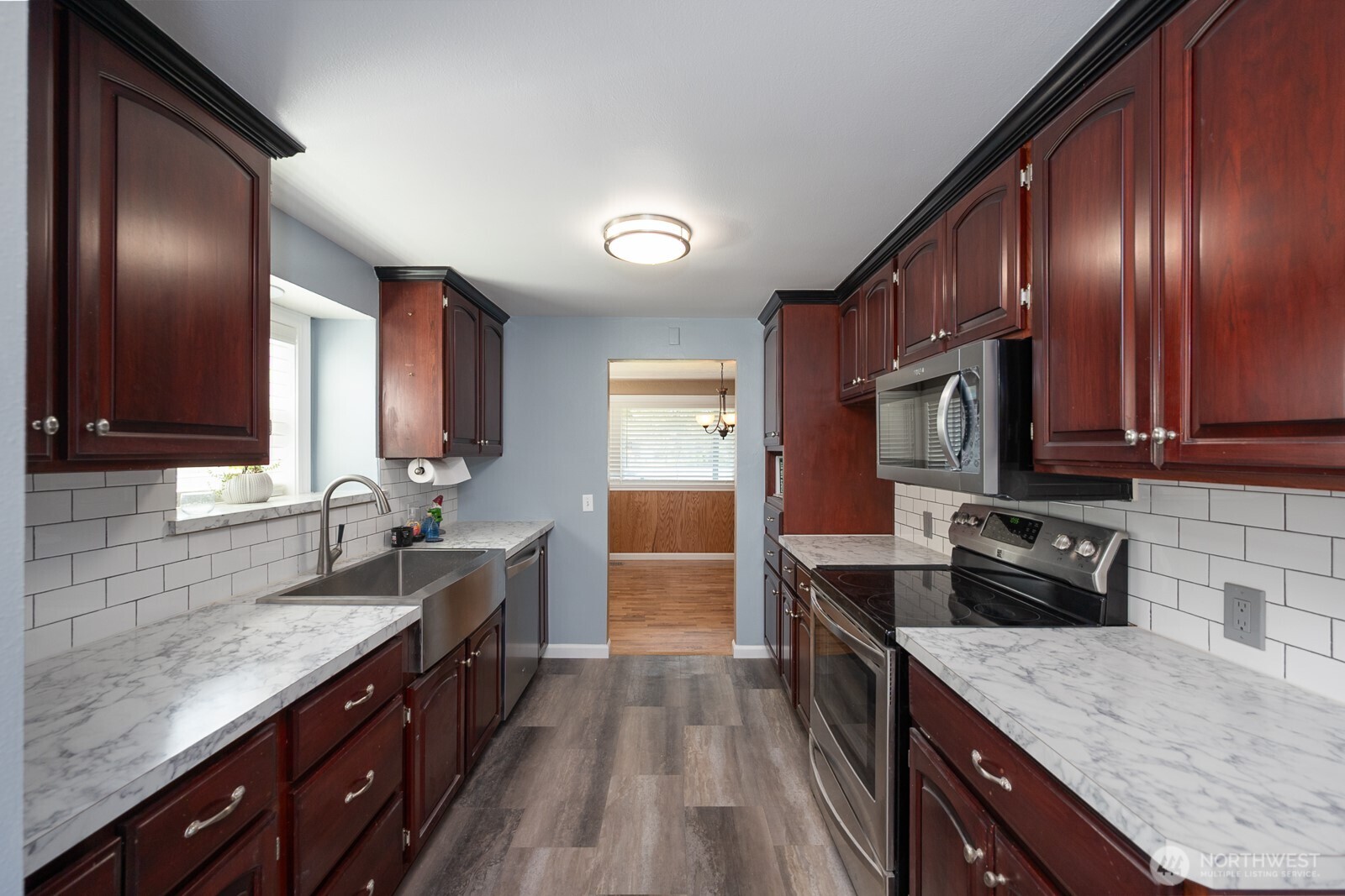 11627 Rd K Northeast Moses Lake, WA 98837 - Photo 15 of 37 a kitchen with a sink stove and cabinets