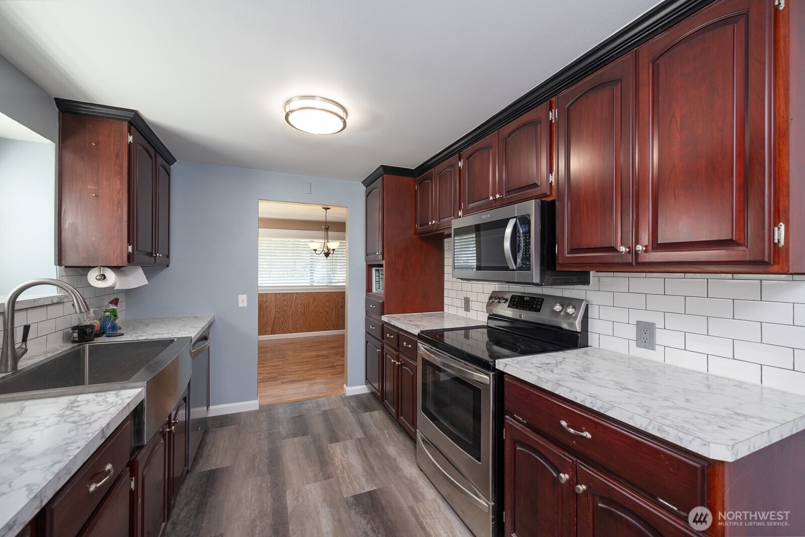 11627 Rd K Northeast Moses Lake, WA 98837 - Photo 16 of 37 a kitchen with granite countertop wooden cabinets stainless steel appliances and a sink