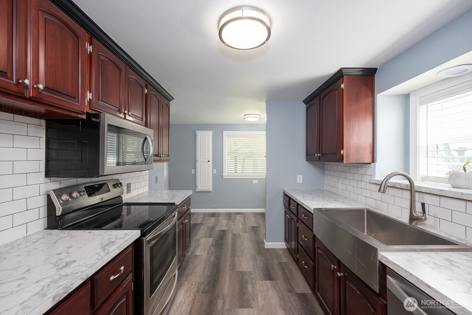 11627 Rd K Northeast Moses Lake, WA 98837 - Photo 18 of 37 a kitchen with granite countertop stainless steel appliances and wooden cabinets