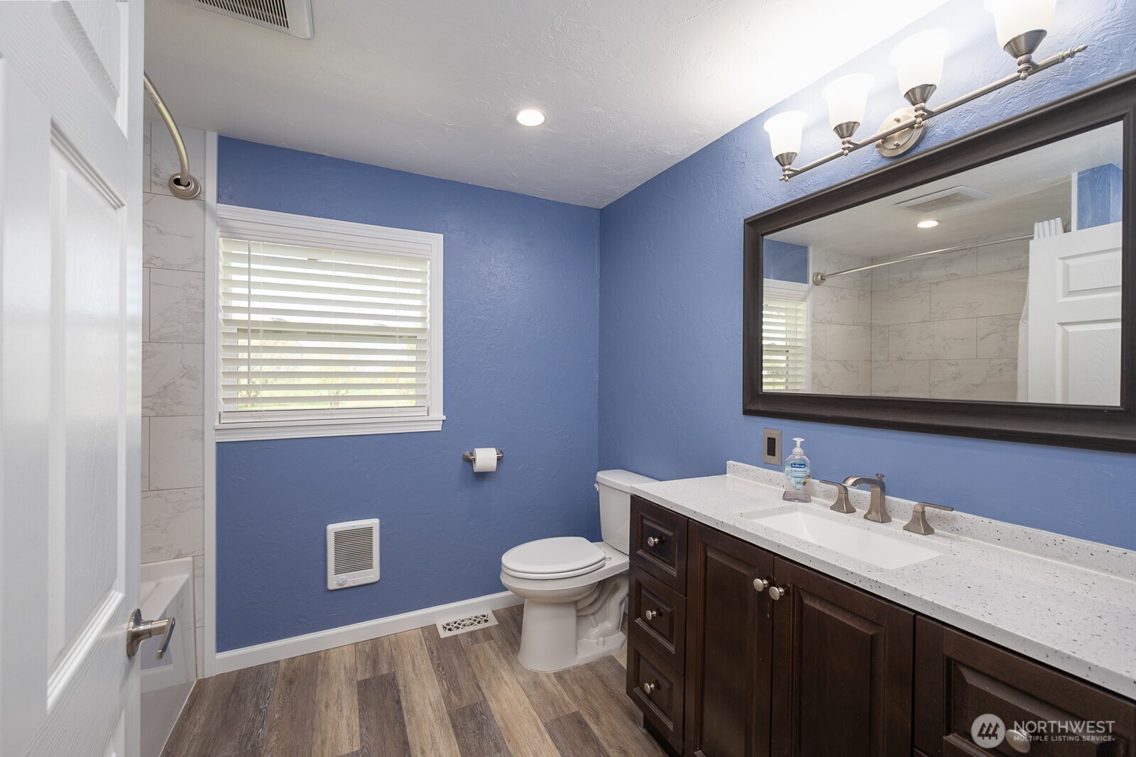 11627 Rd K Northeast Moses Lake, WA 98837 - Photo 21 of 37 a bathroom with a granite countertop toilet a sink a mirror and a window